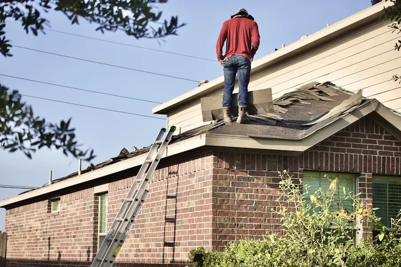 Professional roofer working on a residential roof in Bayside West